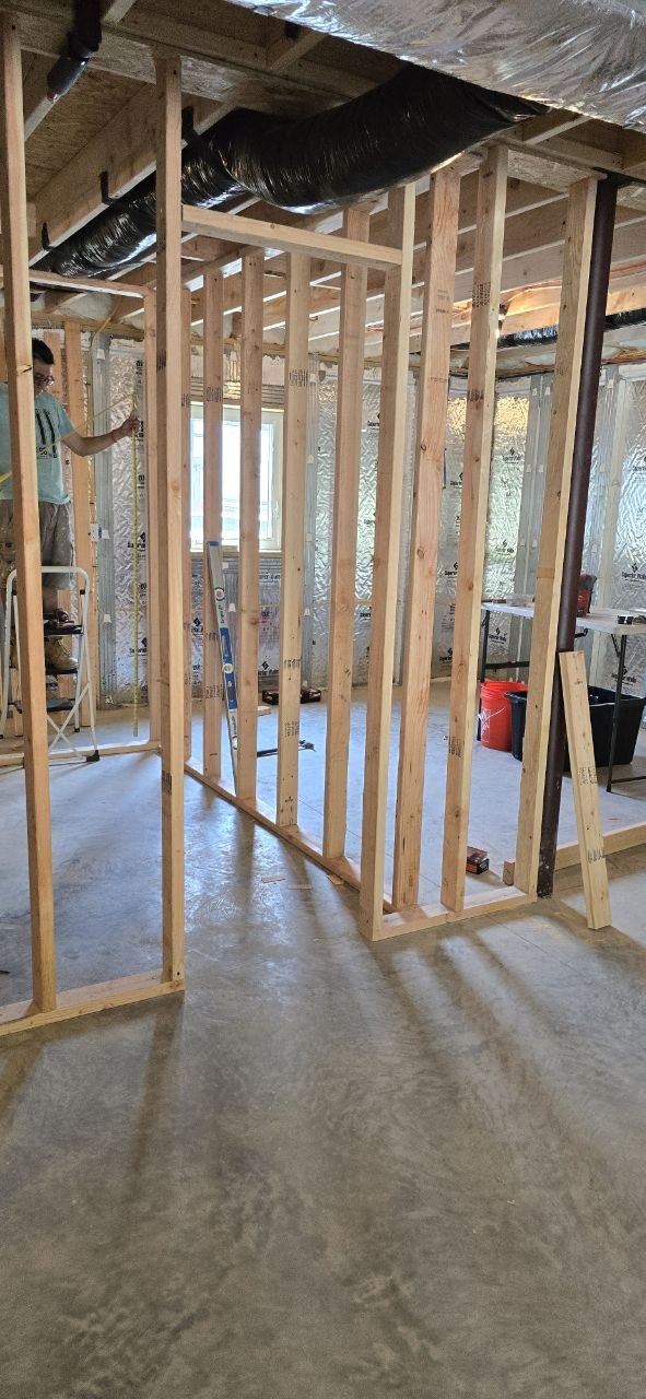 Wood-stud partition wall framing in a basement — J&R Enterprise project